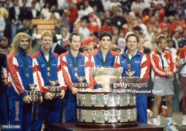 The USA Davis Cup team Rick Leach, Andre Agassi, Jim Courier, John McEnroe, Pete Sampras and Tom Gorman pose with the trophy after defeating...