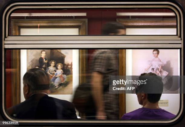 Reproductions of watercolours of the Pushkin Museum of Fine Arts collection are seen inside of the subway transit vehicle in Moscow on May 12, 2010....