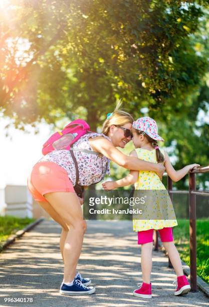mother and daughter walking in the park - ivan jekic stock pictures, royalty-free photos & images