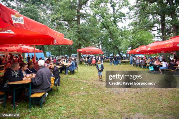 christian and muslim romanies (gypsies), ethnic turks and bulgarians entertaining at a primitive amusement park during the traditional national festivity in the neighborhood of baba kondu in the municipality of targovishte, bulgaria - pavel gospodinov stock pictures, royalty-free photos & images