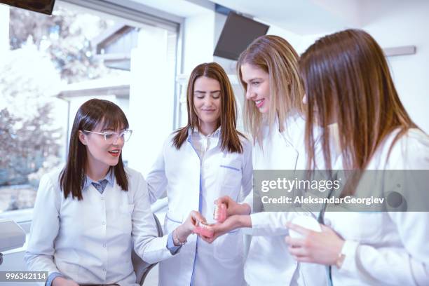 female dentists examining human dentures - dental mould stock pictures, royalty-free photos & images