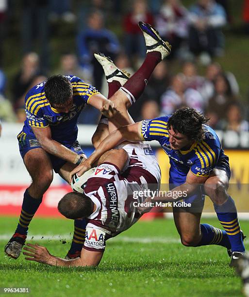 Michael Robertson of the Eagles is tackled during the round ten NRL match between the Manly Sea Eagles and the Parramatta Eels at Brookvale Oval on...