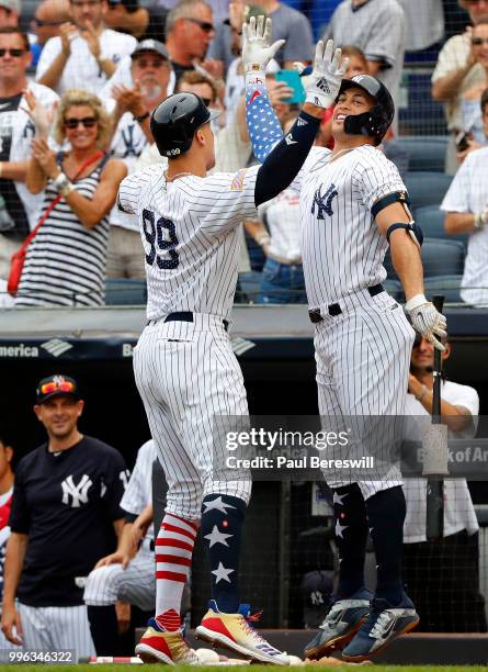 Aaron Judge and Giancarlo Stanton of the New York Yankees celebrate a home run hit by Judge in an interleague MLB baseball game against the Atlanta...