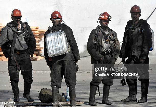 Russian miners rest near the Raspadskaya coal mine, in Mezhdurechensk on May 13, 2010 after making a rescue attempt. The death toll following twin...