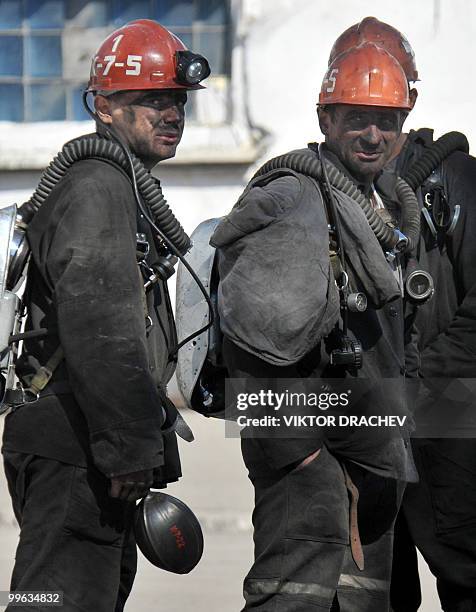 Russian miners rest near the Raspadskaya coal mine, in Mezhdurechensk on May 13, 2010 after making a rescue attempt. The death toll following twin...