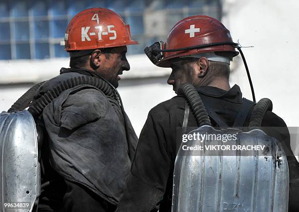 Russian miners speak while resting near the Raspadskaya coal mine, in Mezhdurechensk on May 13, 2010 after making a rescue attempt. The death toll...