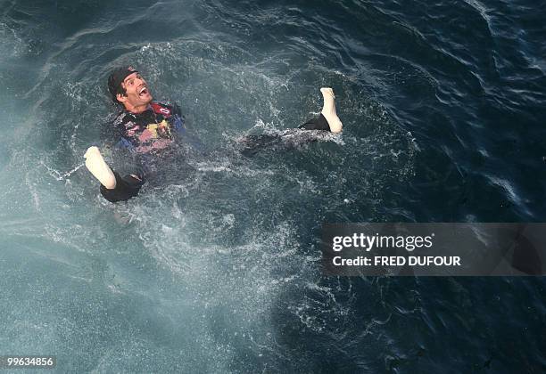 Red Bull's Australian driver Mark Webber celebrates after he jumped in the sea at the Monaco street circuit on May 16 after the Monaco Formula One...