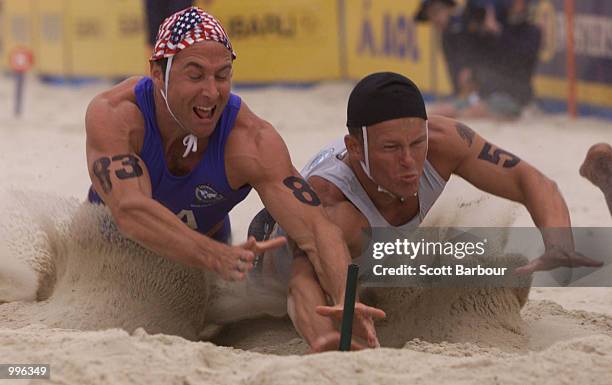 Timothy Green of the USA competes with Morgan Foster of New Zealand during the Mens Beach Flag during Day One of the Surf Lifesaving event at Kurrawa...