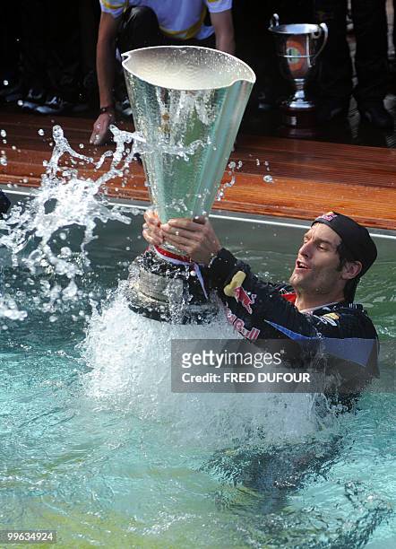 Red Bull's Australian driver Mark Webber celebrates in the pool of his team's hospitality at the Monaco street circuit on May 16 after the Monaco...