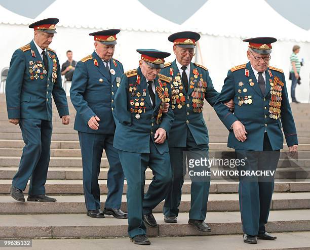 Russian WWII veterans walk through a park in Moscow on May 8, 2010 while attending Victory Day related festivities. French President Nicolas Sarkozy...