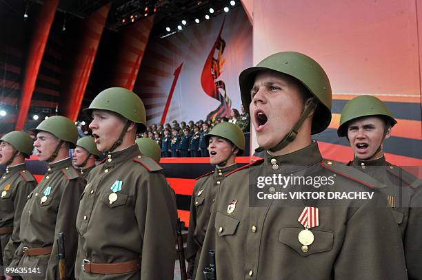 Russian soldiers sing at a park in Moscow on May 8, 2010 during Victory Day related festivities. French President Nicolas Sarkozy has cancelled a...