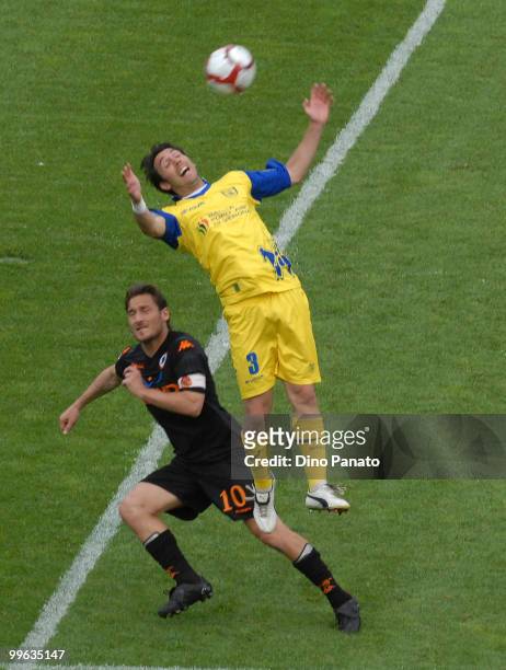 Francesco Totti of Roma competes with Francesco Scardina of Chievo during the Serie A match between AC Chievo Verona and AS Roma at Stadio...