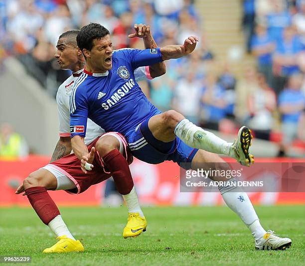Chelsea's German midfielder Michael Ballack cries out in pain as he is tackled by Portsmouth's Kevin-Prince Boateng during the FA Cup Final football...
