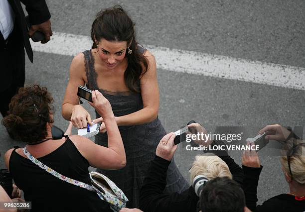 Actress Evangeline Lilly signs autographs as she arrives for the screening of "La Princesse de Montpensier" presented in competition at the 63rd...