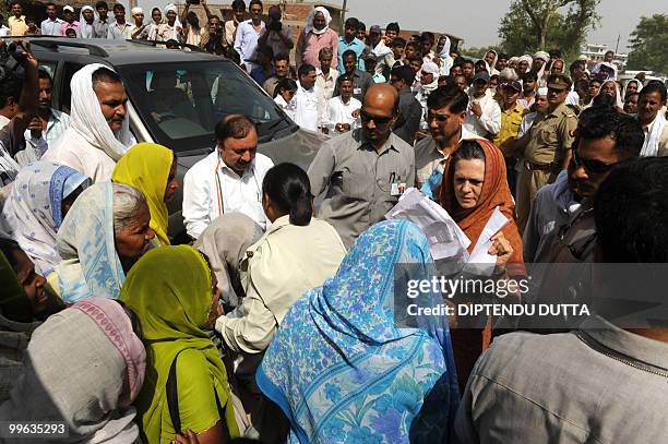 Indian Congress President and United Progressive Alliance Chairperson Sonia Gandhi interacts with supporters at her Rae Bareli constituency in Uttar...