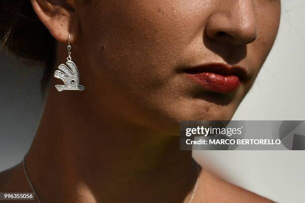 Hostess is pictured during the podium ceremony after the fifth stage of the 105th edition of the Tour de France cycling race between Lorient and...