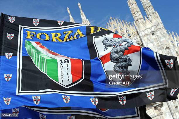 Inter Milan supporters celebrate at Piazza Duomo in Milan with a flag for the 18th Italian Serie A football title won by Inter Milan on May 16, 2010....