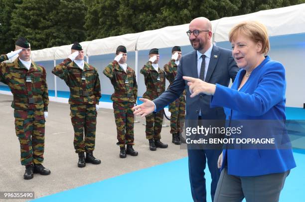 Belgian Prime Minister Charles Michel and Germany's Chancellor Angela Merkel speak as they arrive for a working dinner at The Parc du Cinquantenaire...