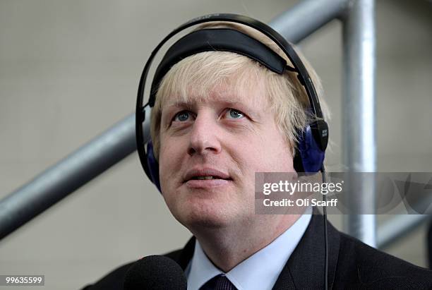 Mayor of London Boris Johnson wears headphones as he attends a press conference to announce the design for London's new Routemaster bus in Battersea...