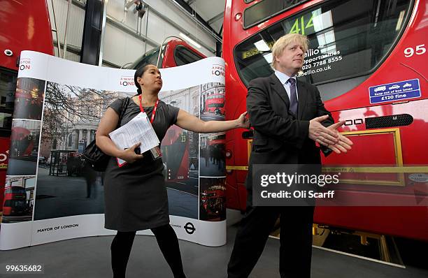 Mayor of London Boris Johnson is directed by his press officer during the announcement of the design for London's new Routemaster bus, in Battersea...