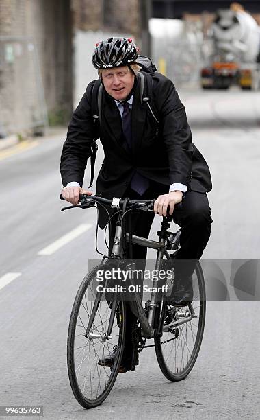 Mayor of London Boris Johnson departs on his bicycle after attending a press conference to announce the design for London's new Routemaster bus, in...