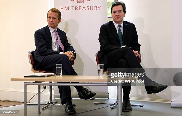 Britain's Chancellor of the Exchequer George Osborne and Treasury Secretary David Laws sit together during a press conference at the Treasury, May...