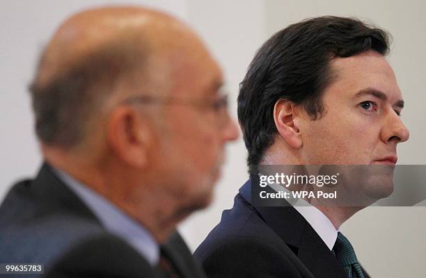 Britain's Chancellor of the Exchequer George Osborne sits next to the Chair of the new Office for Budget Responsibility, Sir lan Budd, during a press...