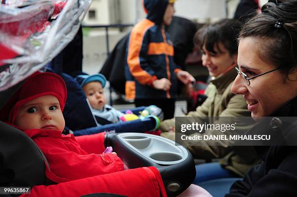 Romanian mothers with their infants protest in the front of the minister of Labour in Bucharest against the Romanian Government's decision to reduce...