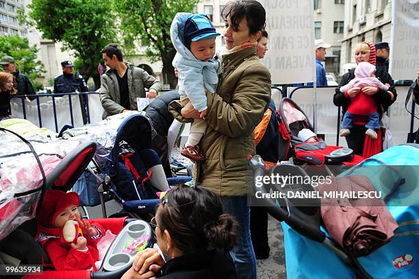 Romanian mothers with their infants protest in the front of the minister of Labour in Bucharest against the Romanian Government's decision to reduce...