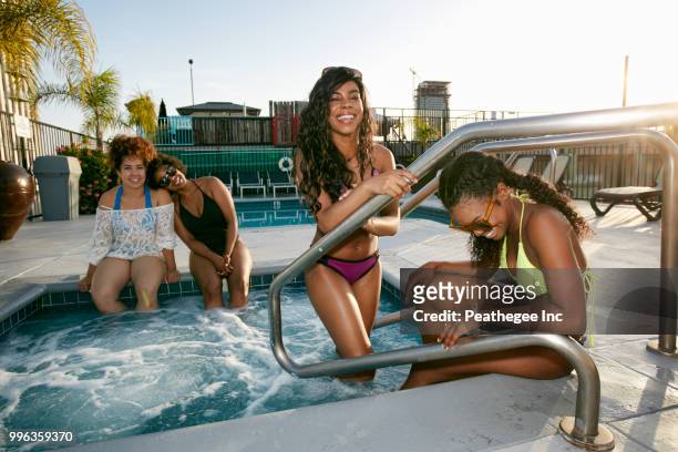 women on rooftop - rooftop pool stock-fotos und bilder