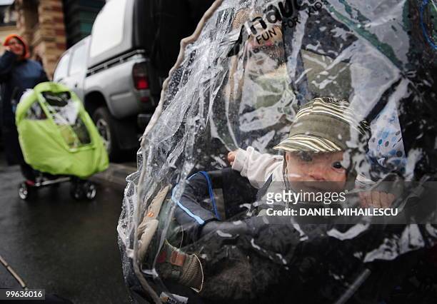 Romanian child looks on during a protest against the decision of the Romanian Government to reduce parental allowance in the front of the ministry of...