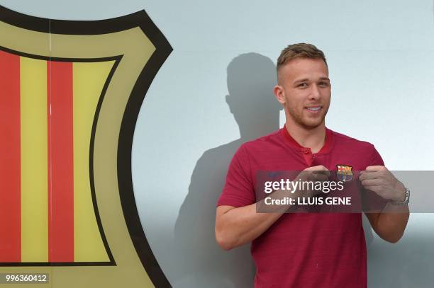 Barcelona's new player Brazilian midfielter Arthur Henrique Ramos de Oliveira Melo poses outside the Camp Nou stadium in Barcelona, prior to signing...