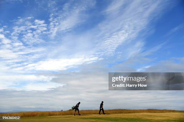 Patrick Reed of the United States and caddie Kessler Karain, make their way to the seventh fairway during the Pro-Am event of the Aberdeen Standard...