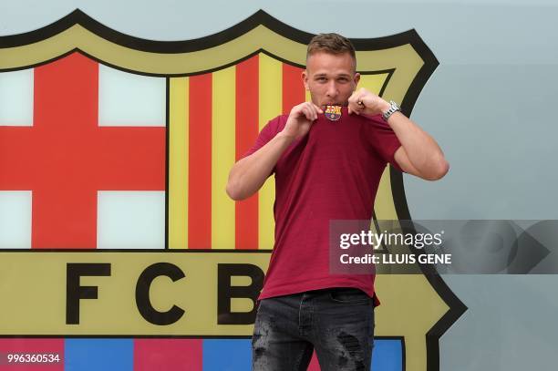 Barcelona's new player Brazilian midfielter Arthur Henrique Ramos de Oliveira Melo poses outside the Camp Nou stadium in Barcelona, prior to signing...