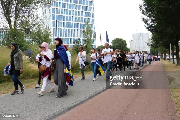 Hundreds of people gather to attend the commemoration ceremony to mark the 23rd anniversary of the 1995 Srebrenica massacre as they pass by...