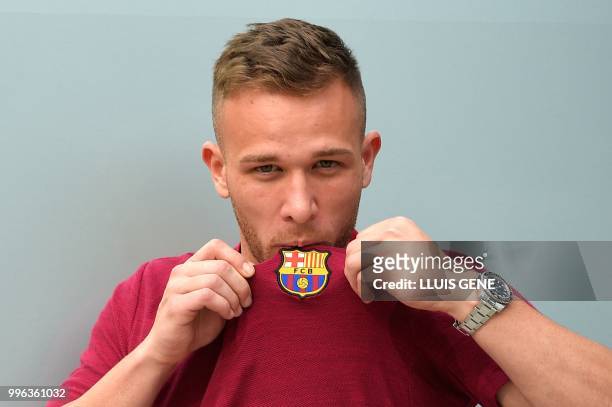 Barcelona's new player Brazilian midfielter Arthur Henrique Ramos de Oliveira Melo poses outside the Camp Nou stadium in Barcelona, prior to signing...