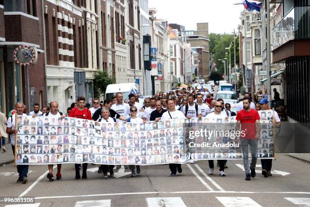 Hundreds of people gather to attend the commemoration ceremony to mark the 23rd anniversary of the 1995 Srebrenica massacre as they pass by...