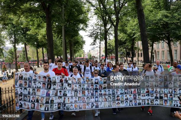 Hundreds of people gather to attend the commemoration ceremony to mark the 23rd anniversary of the 1995 Srebrenica massacre as they pass by...