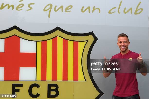 Barcelona's new player Brazilian midfielter Arthur Henrique Ramos de Oliveira Melo poses outside the Camp Nou stadium in Barcelona, prior to signing...