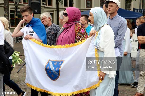 Hundreds of people gather to attend the commemoration ceremony to mark the 23rd anniversary of the 1995 Srebrenica massacre as they pass by...