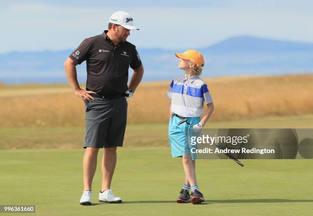 Graeme McDowell of Northern Ireland is pictured with his Junior Pro Am participant on the third hole during the Pro Am event prior to the start of...