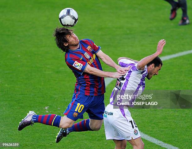 Barcelona's Argentinian forward Lionel Messi fights for the ball with Valladolid's midfielder Jonathan Sesma during their Spanish League football...