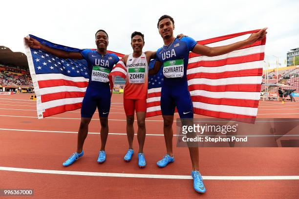Lalu Muhammad Zohri of Indonesia , Anthony Schwartz of The USA and Eric Harrison of The USA celebrate after placing in the medals in the final of the...