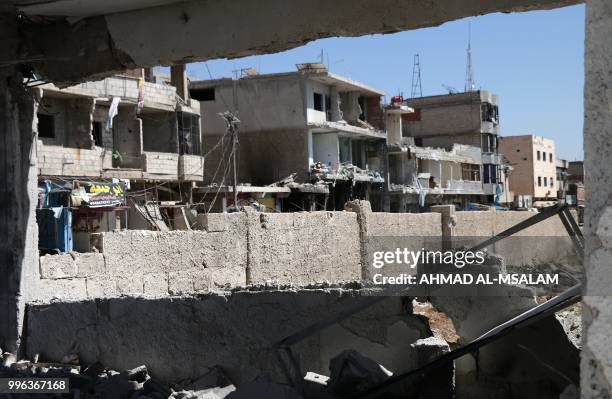 This general view taken on July 11 shows buildings destroyed during airstrikes by Syrian regime forces in the rebel-held town of Nawa, about 30...