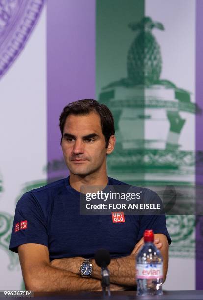 Switzerland's Roger Federer takes part in a press conference after losing to South Africa's Kevin Anderson 2-6, 6-7, 7-5, 6-4, 13-11 in their men's...