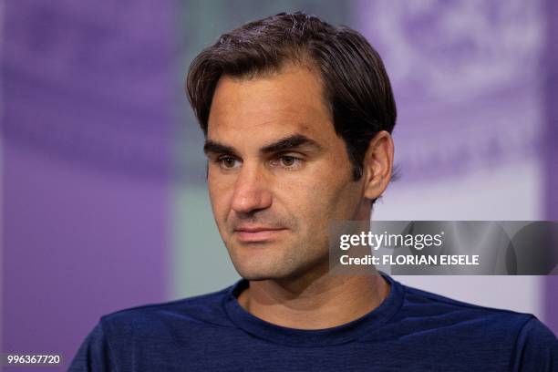 Switzerland's Roger Federer takes part in a press conference after losing to South Africa's Kevin Anderson 2-6, 6-7, 7-5, 6-4, 13-11 in their men's...