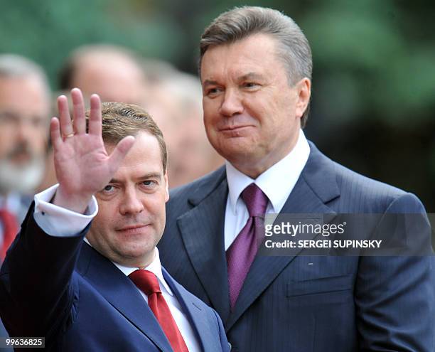 Russian President Dmitry Medvedev gestures next to his Ukrainian counterpart Viktor Yanukovych during an official ceremony in Kiev on May 17, 2010....