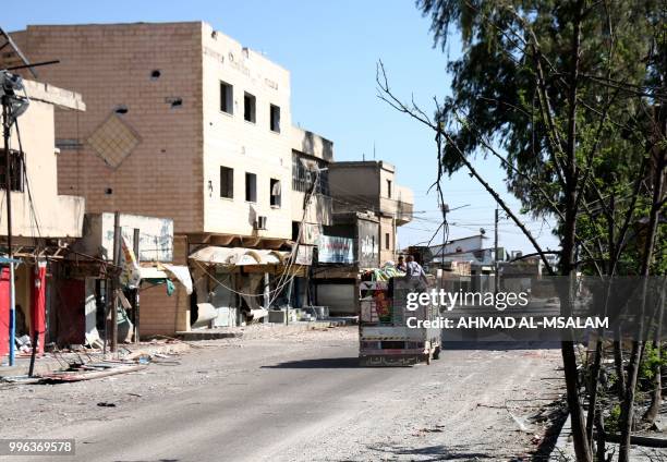 Residents flee the rebel-held town of Nawa, about 30 kilometres north of Daraa in southern Syria on July 11, 2018. - Syrian president Bashar...