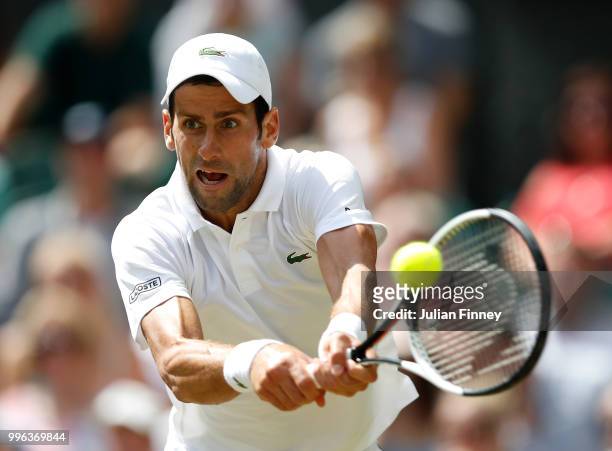 Novak Djokovic of Serbia plays a backhand in his match against Kei Nishikori of Japan action during their Men's Singles Quarter-Finals match on day...