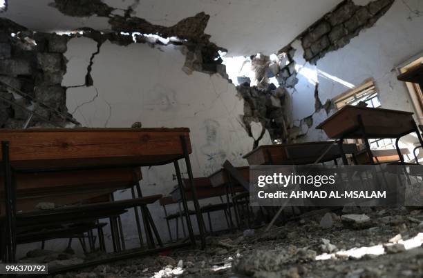 Picture taken on July 11 shows a school heavily damaged during airstrikes by Syrian regime forces in the rebel-held town of Nawa, about 30 kilometres...